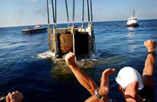 Navy divers celebrate as the turret of the USS Monitor Navy divers celebrate as the turret of the USS Monitor