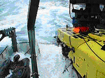 Pisces V, secured to back deck of Ka‘imikai-o-Kanaloa (KoK), rides out some bad weather and rough seas.