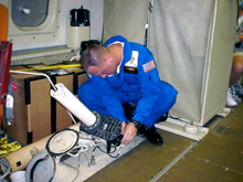 A crew member prepares to deploy a dropwindsonde A crew member prepares to deploy a dropwindsonde
