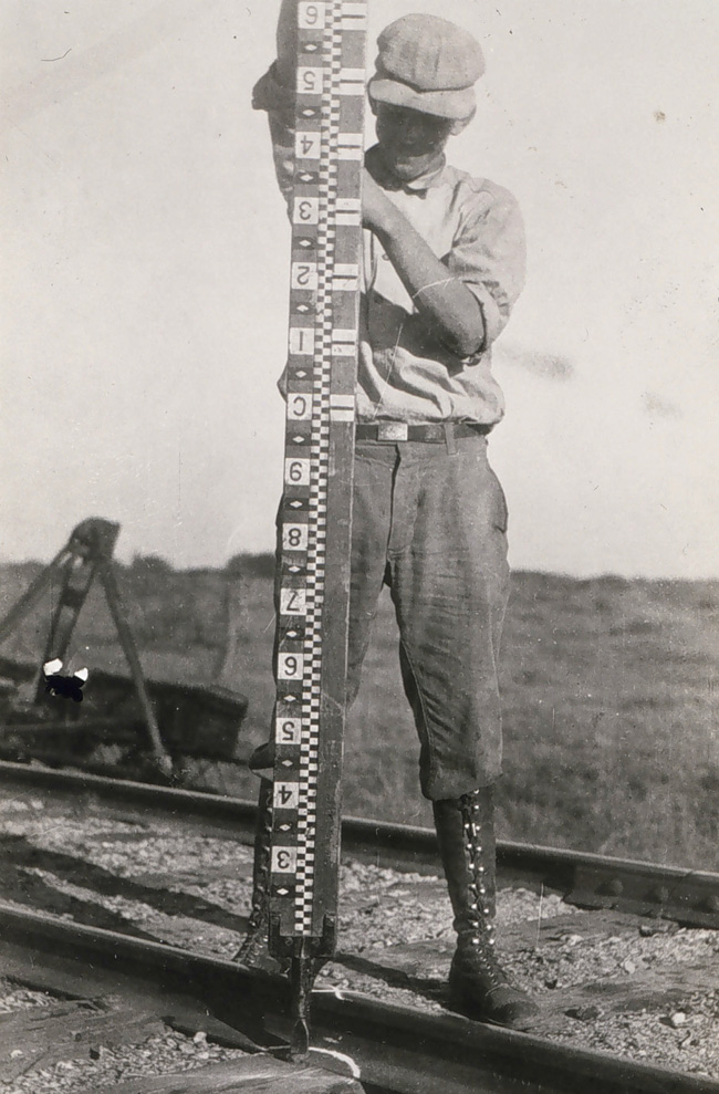 Traditional leveling involved using a level to read numbers marked on a rod, such as this one.