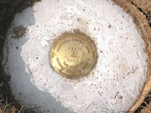 A National Geodetic Survey brass disk set in concrete. A National Geodetic Survey brass disk set in concrete.