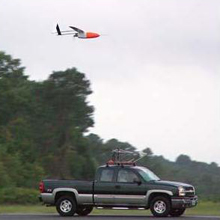 An aerosonde unmanned aerial vehicle is released from its transport vehicle on the runway at the National Aeronautics Space Administration (NASA) Wallops flight facility in Wallops Island, Virginia. An aerosonde unmanned aerial vehicle is released from its transport vehicle on the runway at the National Aeronautics Space Administration (NASA) Wallops flight facility in Wallops Island, Virginia.