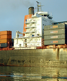Coast Guard chemical specialists enter a Massachusetts shipyard to assess the contents of drums